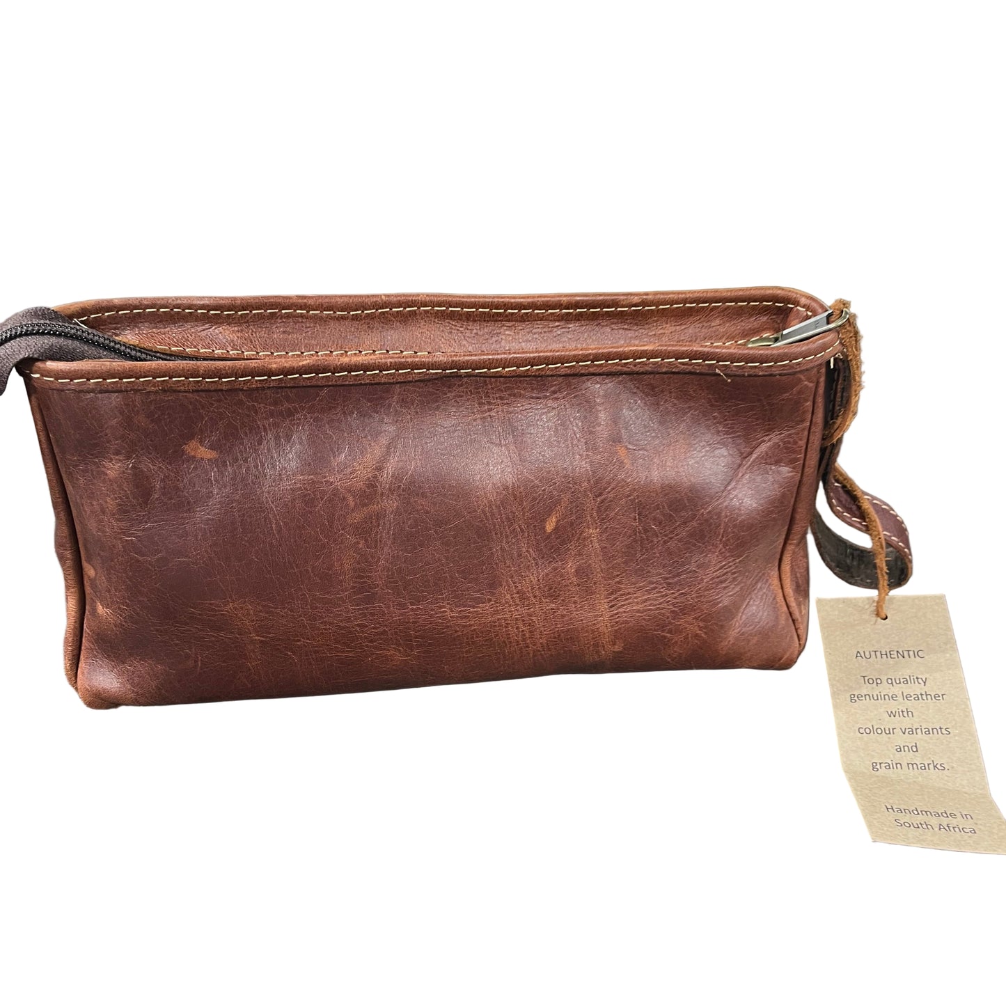 Brown leather wallet on a wooden surface with tools in the background